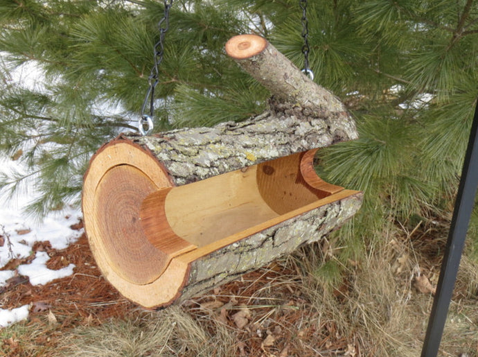 One of our fun bird feeders with a branch, made by Schoolhouse Woodcrafts